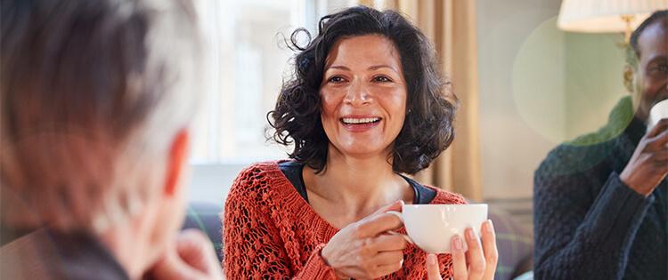 Una mujer sosteniendo una taza.